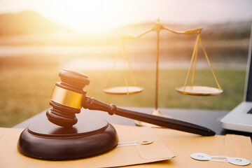 Justice and law concept.Male judge in a courtroom with the gavel, working with, computer and...