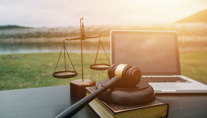Justice and law concept.Male judge in a courtroom with the gavel, working with, computer and...