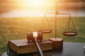 Justice and law concept.Male judge in a courtroom with the gavel, working with, computer and...