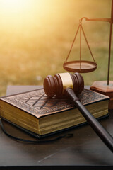 Justice and law concept.Male judge in a courtroom with the gavel, working with, computer and...