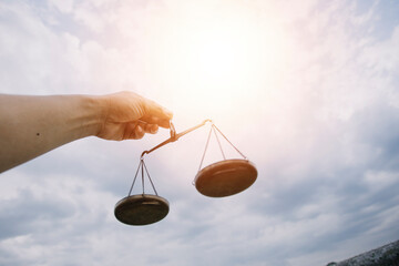 Business and lawyers discussing contract papers with brass scale on desk in office. Law, legal services, advice, justice and law concept picture with film grain effect