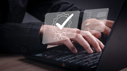 Businessman working on laptop with sign of Quality assurance, Guarantee, ISO certification and...