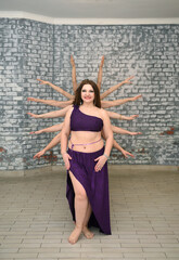 A group of beautiful girls in the outfits of oriental dancers in the studio dance a ritual dance...