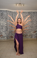 A group of beautiful girls in the outfits of oriental dancers in the studio dance a ritual dance...