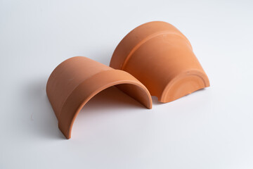 Broken terracotta pot on isolated white background. Manufactured defect. Shipment risk.