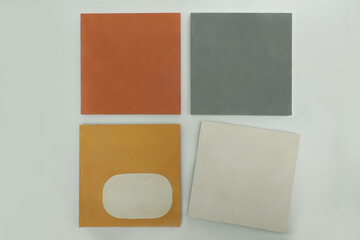 Demonstration layout of decorative concrete tiles for home facades and office spaces of bright colors. Stone tiles in grey orange yellow and white colours on the exhibition stand