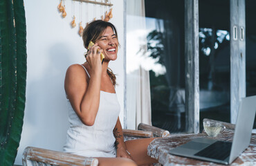 Young woman working on terrace of resort hotel