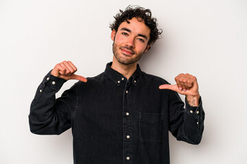 Young caucasian man isolated on white background feels proud and self confident, example to follow.