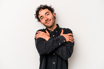 Young caucasian man isolated on white background hugs, smiling carefree and happy.