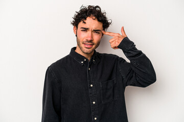 Young caucasian man isolated on white background showing a disappointment gesture with forefinger.