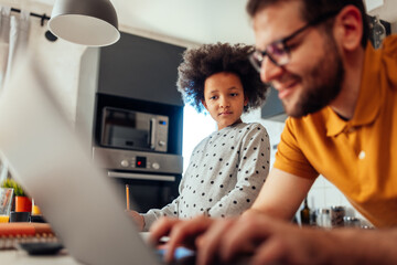 Man is working from home and babysitting