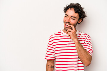 Young caucasian man isolated on white background relaxed thinking about something looking at a copy space.