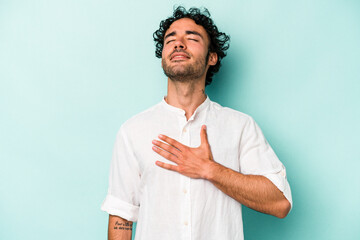 Young caucasian man isolated on white background laughs out loudly keeping hand on chest.