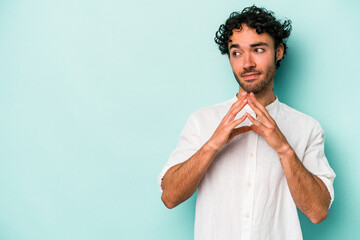 Young caucasian man isolated on white background making up plan in mind, setting up an idea.