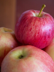 A few ripe striped apples, a close-up shot. Apples of the gala and Ligol varieties.