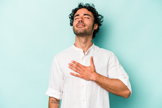 Young caucasian man isolated on white background laughs out loudly keeping hand on chest.