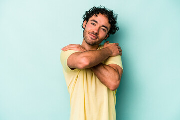 Young caucasian man isolated on white background hugs, smiling carefree and happy.