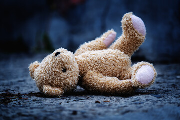 Conceptual photography: war, death and lost childhood. Conceptual picture of a children's toy teddy...