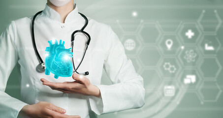 Unrecognizable female doctor holding graphic virtual visualization model of Heart organ in hands....