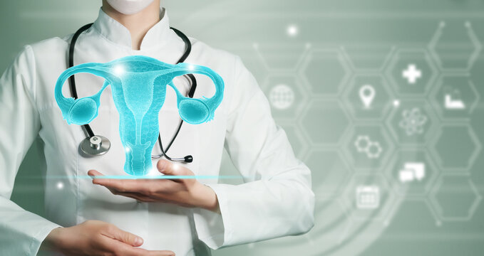 Unrecognizable female doctor holding graphic virtual visualization model of Uterus organ in hands. Multiple medical icons on the background.