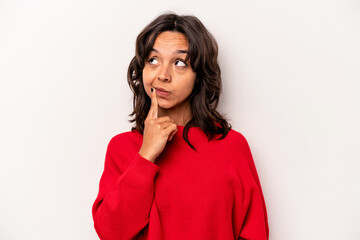 Young hispanic woman isolated on white background contemplating, planning a strategy, thinking about the way of a business.