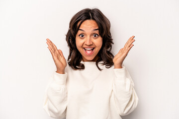 Young hispanic woman isolated on white background receiving a pleasant surprise, excited and raising hands.