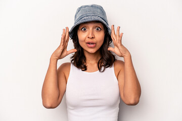 Young hispanic woman isolated on white background receiving a pleasant surprise, excited and...