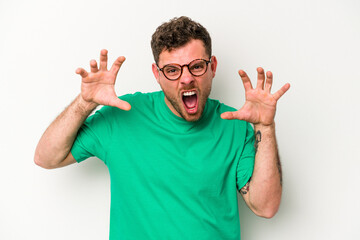 Young caucasian man isolated on white background showing claws imitating a cat, aggressive gesture.