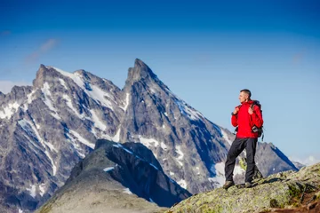 Fotobehang caucasian man hiking in mountains © olyphotostories