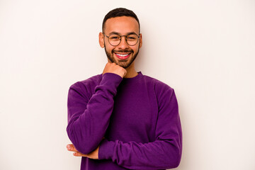 Young hispanic man isolated on white background smiling happy and confident, touching chin with hand.