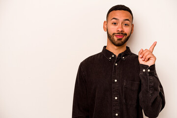 Young hispanic man isolated on white background showing number one with finger.