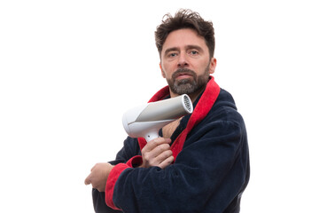 Adult male in a robe posing with a dryer blower on the white background
