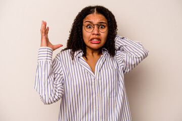 Young African American woman isolated on white background screaming with rage.