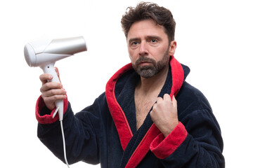 Adult male in a robe posing with a dryer blower on the white background