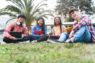 College student friends sitting in the campus park looking to camera - Diversity in University Education 