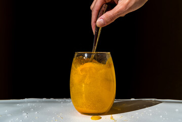 orange juice powder diluted in a glass of water, freshness, vitality concept, health, wellbeing