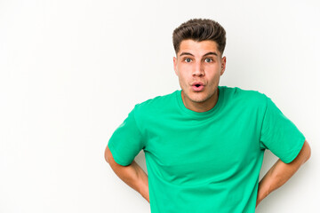 Obraz premium Young caucasian man isolated on white background being shocked because of something she has seen.