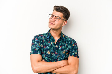Young caucasian man isolated on white background dreaming of achieving goals and purposes