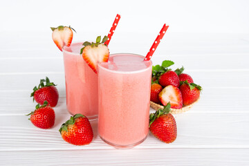 Strawberry yogurt fruit juice smoothie pink colorful fruit juice milkshake blend beverage healthy high protein the taste yummy In glass drink episode morning on white wood background.