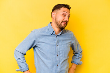 Young hispanic man isolated on yellow background dreaming of achieving goals and purposes