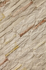 Diagonal modern white brick wall with brown inclusions. Background close-up.