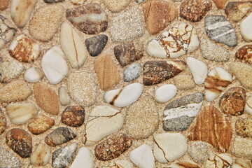 Floor tiles for home renovation, brown and white pebbles in a nautical style, background texture of stone.