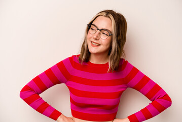 Young caucasian woman isolated on white background laughs happily and has fun keeping hands on...