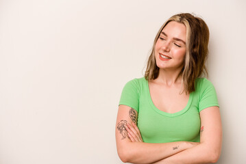 Young caucasian woman isolated on white background smiling confident with crossed arms.