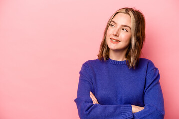 Fototapeta premium Young caucasian woman isolated on pink background smiling confident with crossed arms.