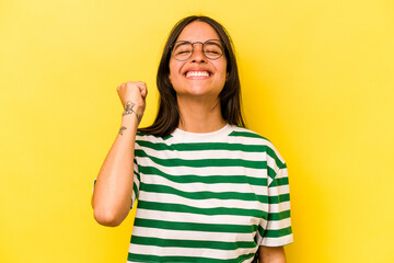 Young hispanic woman isolated on yellow background celebrating a victory, passion and enthusiasm, happy expression.