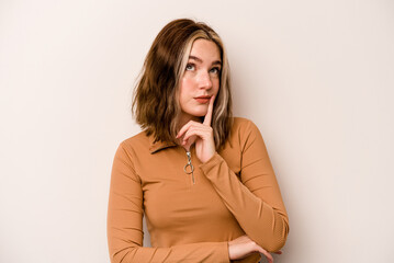 Young caucasian woman isolated on white background contemplating, planning a strategy, thinking about the way of a business.