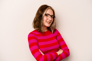 Young caucasian woman isolated on white background who feels confident, crossing arms with determination.