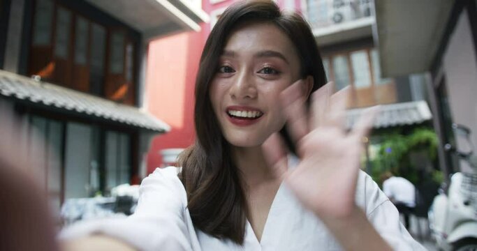 Young girl smiling face waving hand talking to webcam make video call at cafe