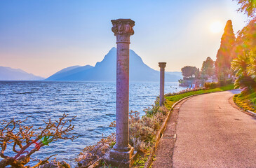 The pleasant romantic walk along the shore of Lugano Lake, enjoying magnificent sunset, Switzerland